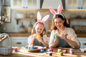 Mom and daughter painting easter eggs