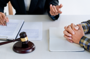 Photo of a father talking to a family law attorney about being denied parenting time and a gavel on a table.